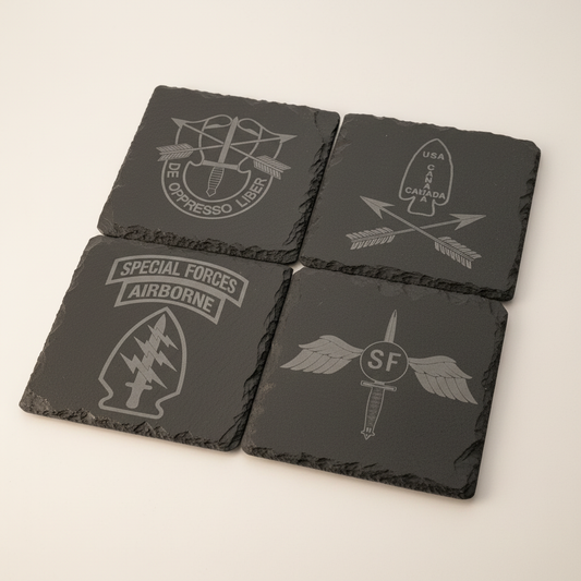 SF Slate Coaster Set arranged as four dark slate coasters with engraved Special Forces designs on a warm-white studio background